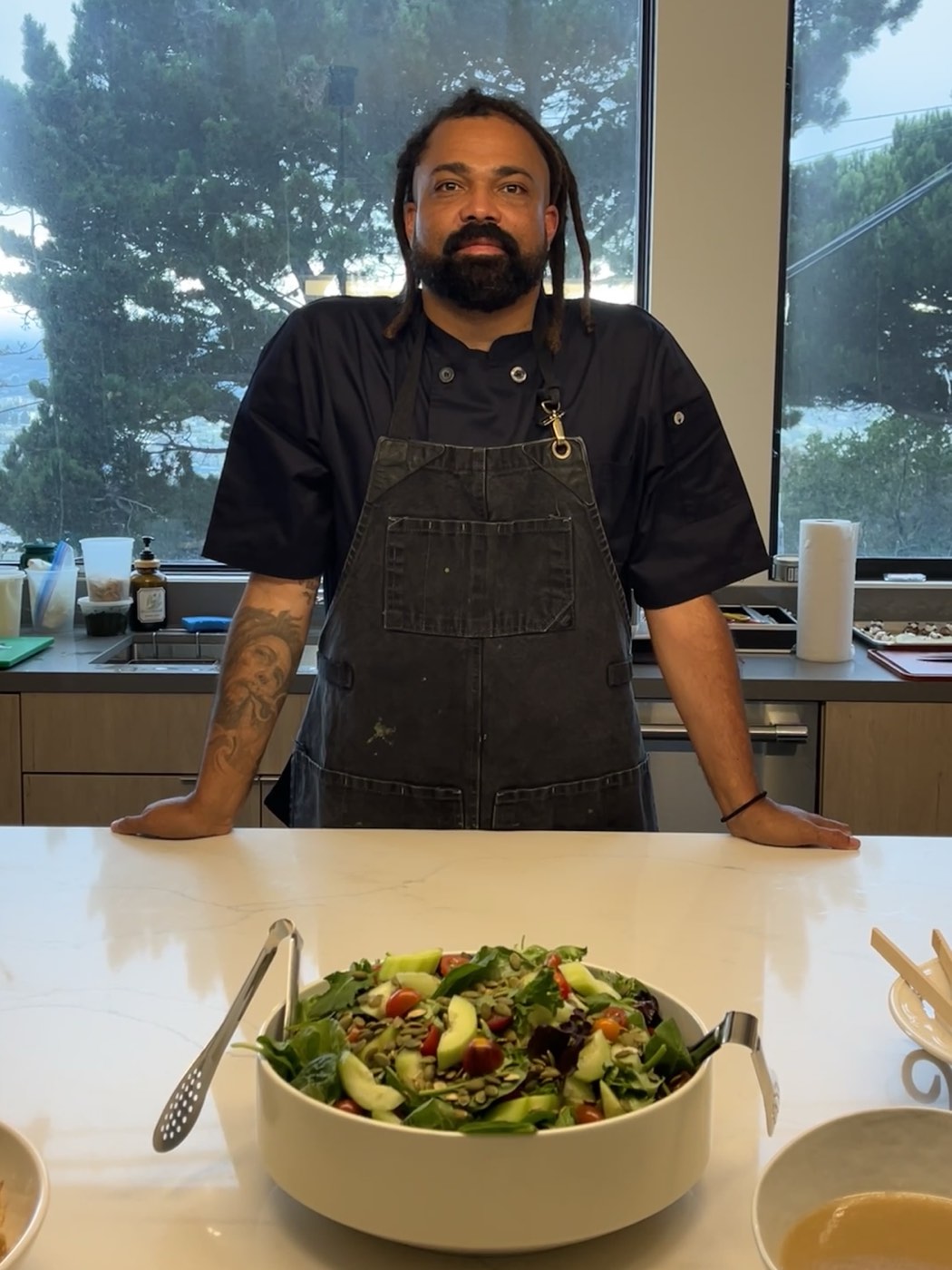 Chef Manny with a fresh garden salad ready to serve