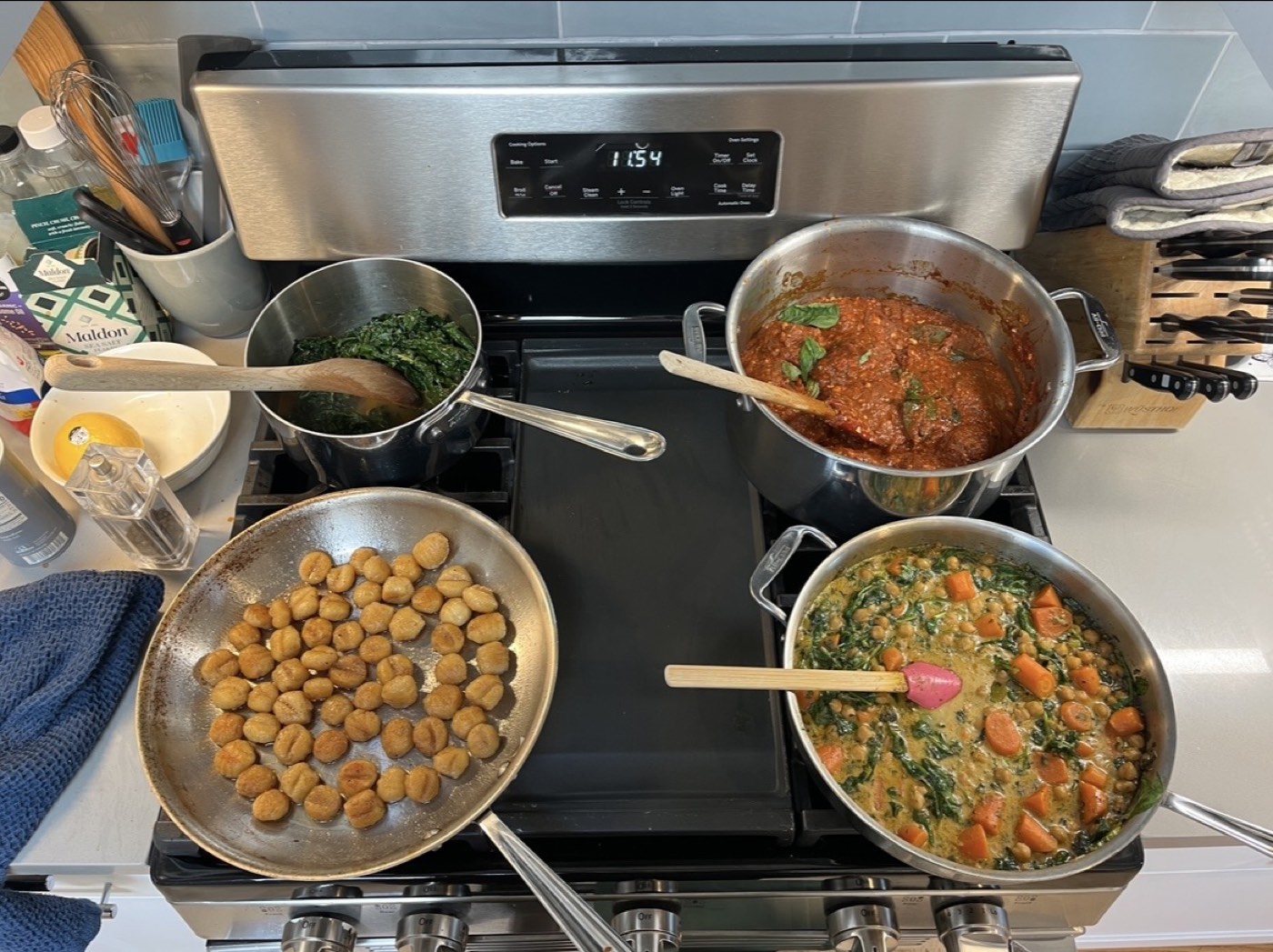 Stovetop prep with saut&eacute;ed greens, tomato sauce, and chickpea curry