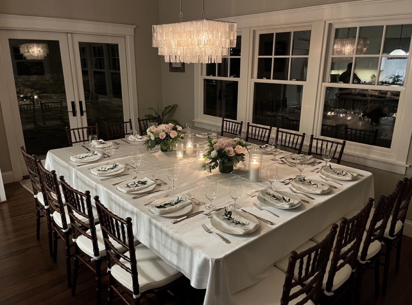 Elegant table setting with floral centerpieces and candlelight