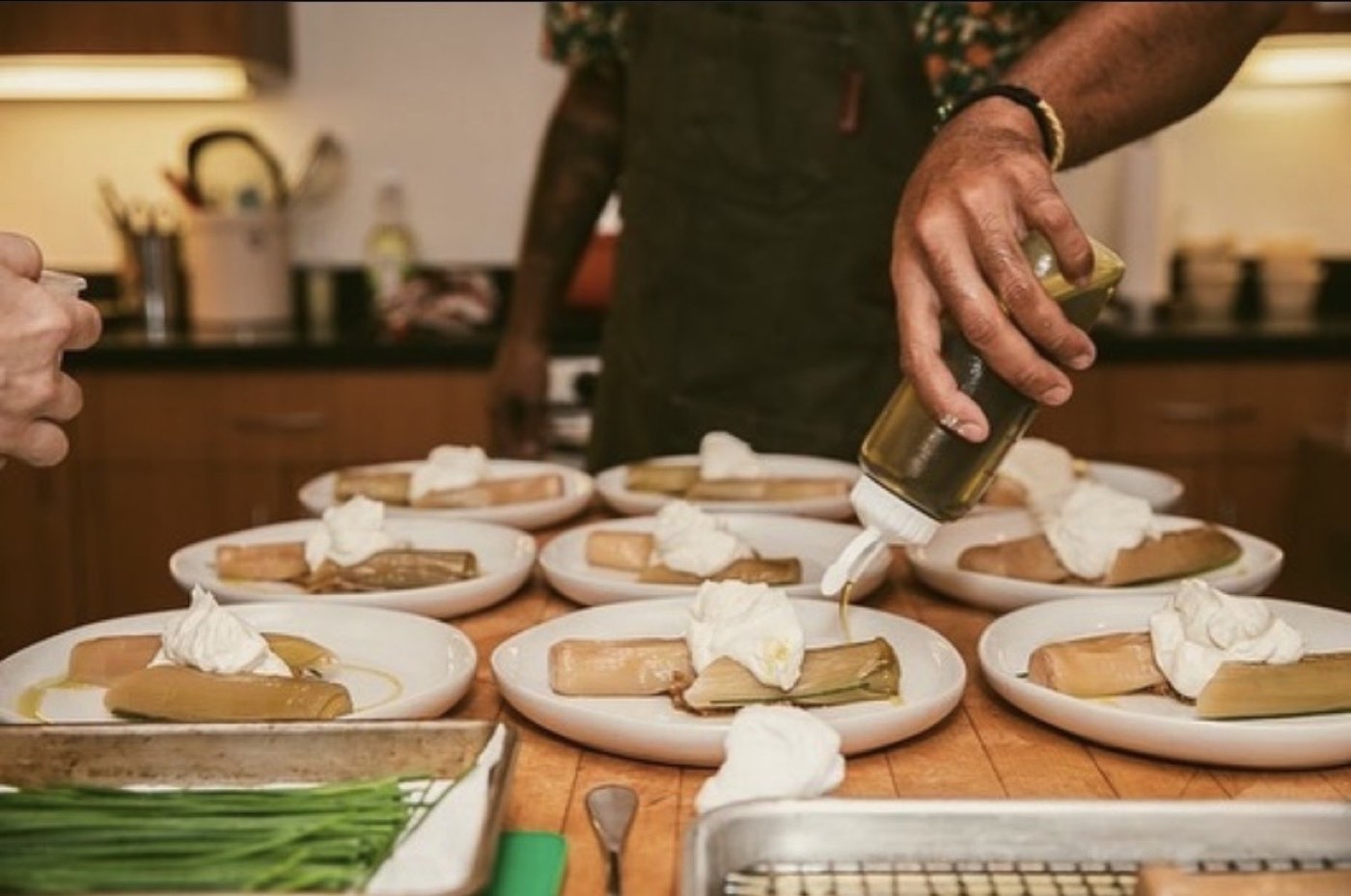 Plating a dessert course with a drizzle of olive oil
