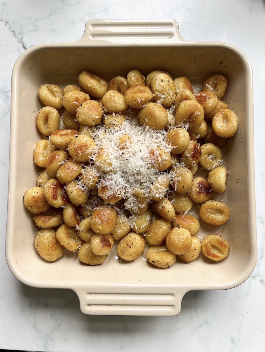 Pan-seared gnocchi with shaved parmesan